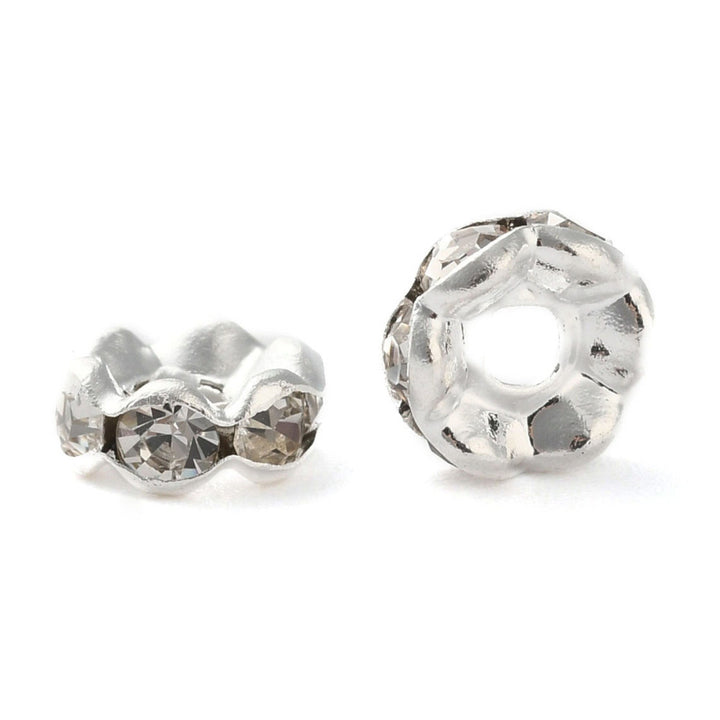 Silver Plated Brass Crystal Rondelle Rhinestone Spacer Beads, Wavy Edge, Shinny Silver Spacer Beads for DIY Jewelry Making. Add Some Shine and Sparkle to Your Creations.  Size: 8mm in Diameter, 3.5mm Thick, Hole Size: approx. 1.5mm, approx. 50pcs/bag.  Material: Brass Silver Plated Rondelle Spacer Beads. Wavy Edge. Each Spacer Bead Features 6 Clear Sparkling Mini Crystals. 