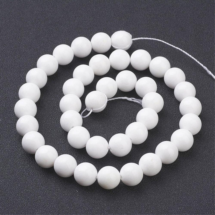 Mashan White Jade Beads, Round, White Color. Semi-Precious Gemstone Beads for Jewelry Making. Affordable and Great for Stretch Bracelets.  Size: 10mm Diameter, Hole: 1mm; approx. 40pcs/strand, 15.5" Inches Long.  Material: Mashan White Jade. Dyed White Color. Polished, Shinny Finish.