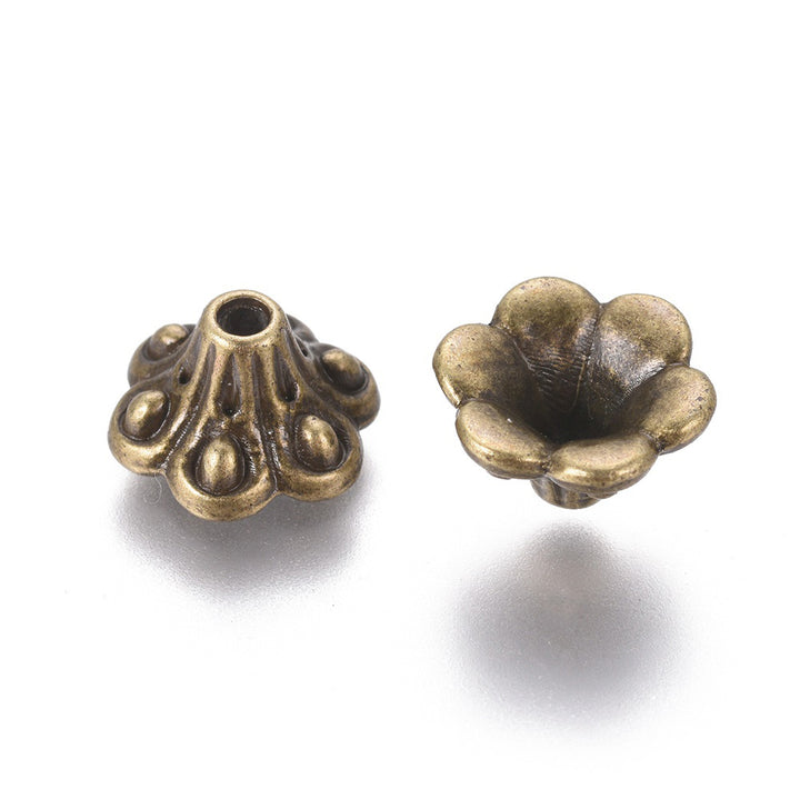 Antique Bronze Bell shaped Alloy Flower Spacer Beads. Flower Shaped Bead Caps, Bronze Color Bead Cones. Flower Spacers for DIY Jewelry Making Projects.   Size: 9mm Diameter, 5mm Length, Hole: 1.5mm, approx. 20pcs/package.  Material: Alloy Flower Bead Caps. Antique Bronze Color. Lead, Cadmium and Nickel Free.