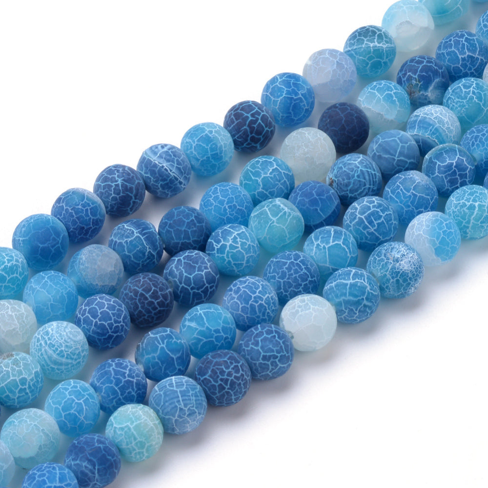 Natural Crackle Agate Beads, Dyed, Round, Blue Color. Matte Semi-Precious Gemstone Beads for Jewelry Making. Great for Stretch Bracelets and Necklaces.  Size: 6mm Diameter, Hole: 1.5mm; approx. 61pcs/strand, 14.5" Inches Long.  Material: Natural & Dyed Crackle Agate, Frosted Blue Color with White Crackle Pattern. The Crackle Appearance is Created by Heating the Stone to Extreme Temperatures. Unpolished, Matte Finish.