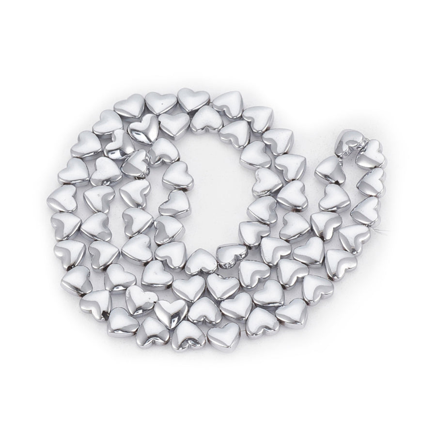 Non-Magnetic Hearth Shaped Synthetic Hematite Beads, Platinum Silver Color. Semi-Precious Stone Spacer Beads for Jewelry Making.   Size: 7mm Length, 5.5mm Width, Hole: 1mm, approx. 68-70pcs/strand, 15" Inches Long.  Material: Non-Magnetic Synthetic Hematite Beads. Platinum Plated Flat Heart Shaped Spacer Beads. Polished, Shinny Metallic Lustrous Finish.