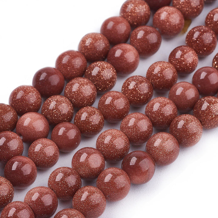 Synthetic Goldstone Beads, Round, Brown Color. Semi-Precious Gemstone Beads for DIY Jewelry Making. Great for Mala Bracelets.   Size: 6mm Diameter, Hole: 1mm; approx. 62pcs/strand, 14" Inches Long.  Material: Synthetic Goldstone Beads. High Quality Man Made Stone. Brown Color with Lots of Glitter. Shinny, Polished Finish. 