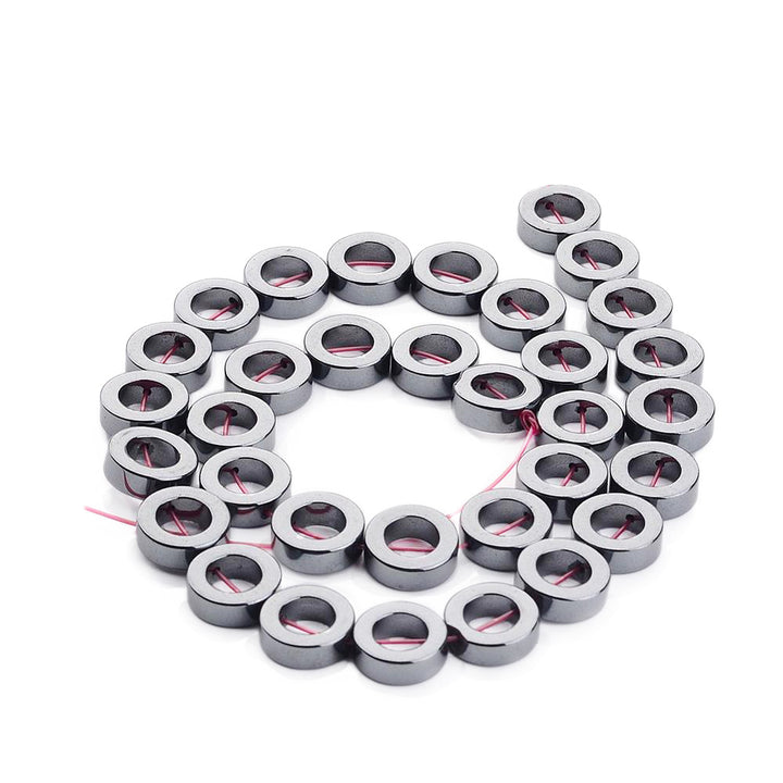 Donut Shaped Non-Magnetic Hematite Beads, Metallic Gunmetal Color. Semi-Precious Stone Beads for Jewelry Making. Affordable High Quality Beads for Mala Bracelets.  Size: 12mm Diameter, 4mm Thick, 6.7-7.2mm Inner Diameter, Hole: 1mm, approx. 33pcs/strand, 15 Inches Long.  Material: Grade AAA, Premium Quality Non-Magnetic Hematite Bead Strands. Metallic Gunmetal/Silver Colored Stone Beads. Polished, Shinny Metallic Lustrous Finish.