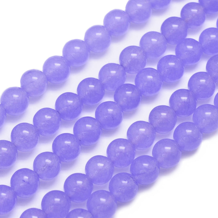 Natural Jade Bead Strand, Round, Lilac Color. Semi-Precious Crystal Gemstone Beads for Jewelry Making. Lilac Jade Beads are Affordable and Great for Stretch Bracelets.  Size: 6mm in diameter, hole: 0.8mm; approx. 62pcs/strand, 14.75" inches long.  Material: The Beads are Natural White Jade, Dyed a Lilac Color. Polished, Shinny Finish.