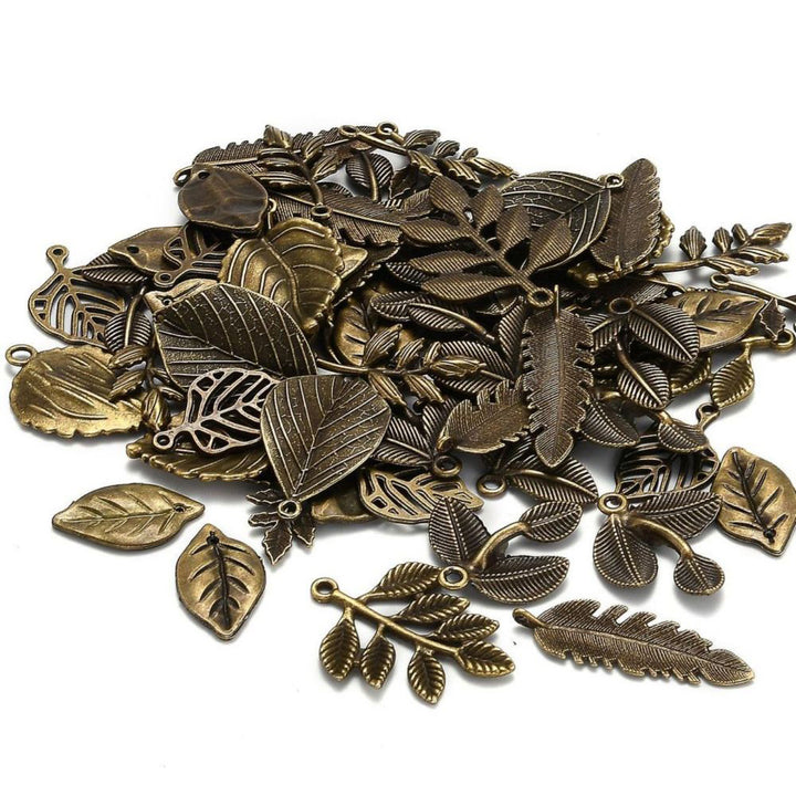 Random Assortment of Leaf Charms in various sizes., Antique Bronze Colored Leaf Charms for Jewelry Making. Mixed Assortment of Leaf Pendants.  Size: Mixed Shapes and Sizes, Hole: 1mm, Quantity: 25 pcs/bag.  Material: Alloy (Lead, Cadmium and Nickel Free) Charms. Antique Bronze Color. 