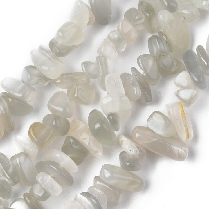 Natural Moonstone Chip Beads, White color, Pale White Grey Color. Semi-Precious Stone Chips for Jewelry Making.  Size: 5-8mm width, 5-8mm length, hole: 1mm; approx. 31.5 inches long.  Material: Genuine White Moonstone Chip Bead Strands. Clear White Moonstone Chips. Pale White/grey Colored Chip Beads. Polished, Shinny Finish.