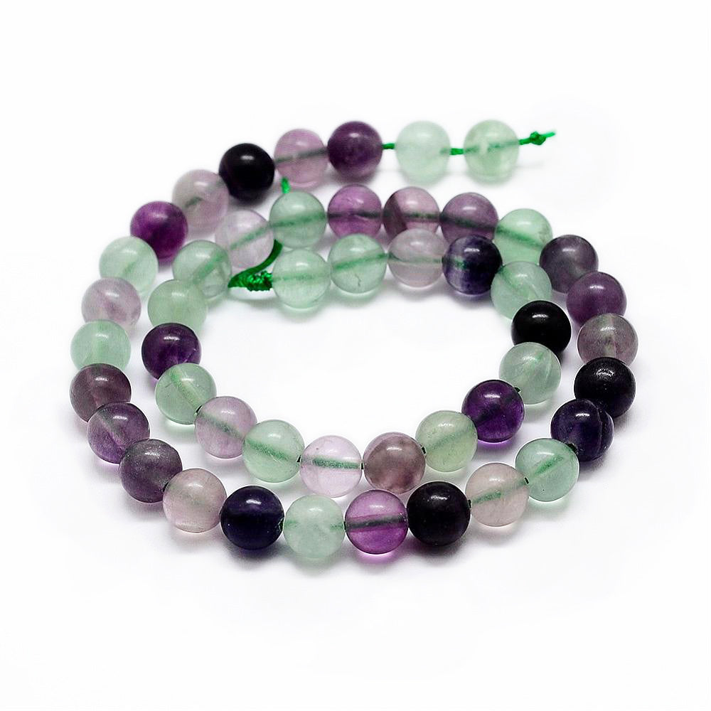 Natural Rainbow Fluorite Bead Strands, Round, Fluorite Gemstone Beads for DIY Jewelry Making. Semi-precious Fluorite Bead Strands Contain Various Shades of Green and some Purple Beads with Specs of White.  The Primary Color of the Beads is a Light Green. Size: 6mm in diameter, hole: 1mm; approx. 61pcs/strand, 15" inches long.