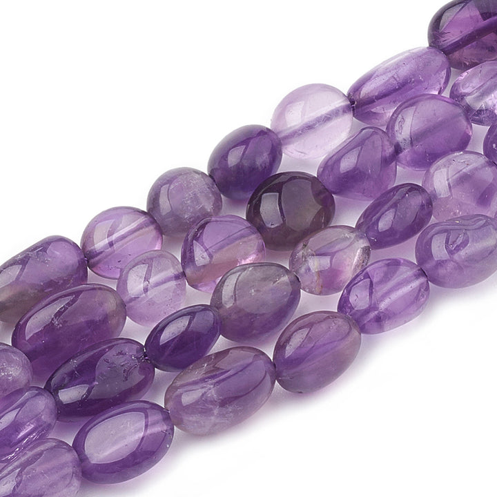 Amethyst Oval Tumbled Stone Beads. Amethyst Nuggets, Purple color. Natural Stone Chip Beads for DIY Jewelry Making.  Size: 5-15mm x 4-10mm x 2-6mm, Hole: 1mm; approx. 40-60pcs/strand; 15 Inches Long.  Material: Genuine Natural Amethyst Beads, High Quality Crystal Oval Tumbled Stone Beads. Polished, Shinny Finish. 