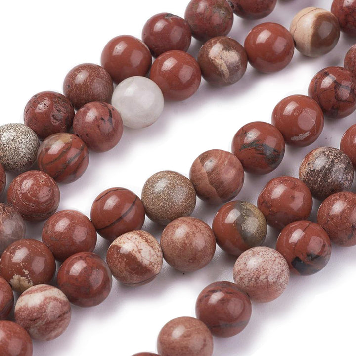 Red Jasper Beads, Round, Red Color. Semi-Precious Gemstone Beads for Jewelry Making. Affordable High Quality Beads, Great for Stretch Bracelets.  Size: 6mm Diameter, Hole: 1mm; approx. 60pcs/strand, 15" inches long.  Material: Genuine Red Jasper Stone. Reddish Brown Color. Polished, Shinny Finish