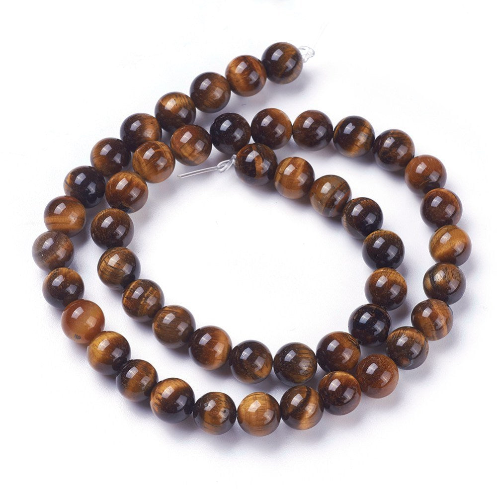 Premium Grade Tiger Eye Beads, Round, Dark Goldenrod Color. Semi-precious Gemstone Tiger Eye Beads for DIY Jewelry Making.  High Quality Beads for Making Mala Bracelets. Size: 8mm in diameter, hole: 1mm, approx. 48pcs/strand, 15 inches long.  Material: Grade AB+ Genuine Natural Dark Goldenrod Tiger Eye Loose Stone Beads, High Quality Polished Stone Beads. Shinny, Polished Finish. www.beadlot.com