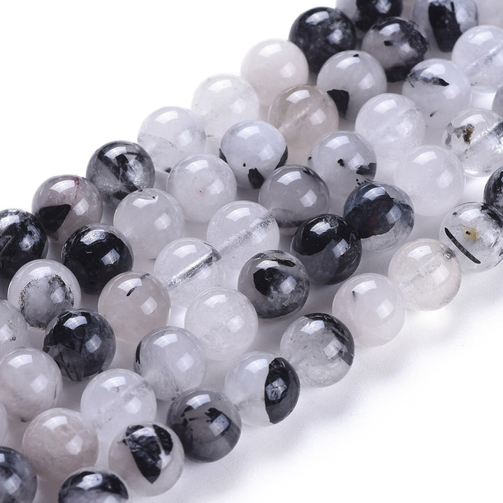 Natural Rutilated Quartz, Black Rutilated Quartz Beads, Round, White and Black Color. Semi-precious Rutilated Quartz Gemstone Beads for DIY Jewelry Making.    Size: 8mm Diameter, Hole: 1mm, approx. 48pcs/strand, 15.5 inches long.  Material: Genuine Natural Rutilated Quartz Beads, Round, Loose Stone Beads. Pale White Color with Black Markings. Polished, Shinny Finish.