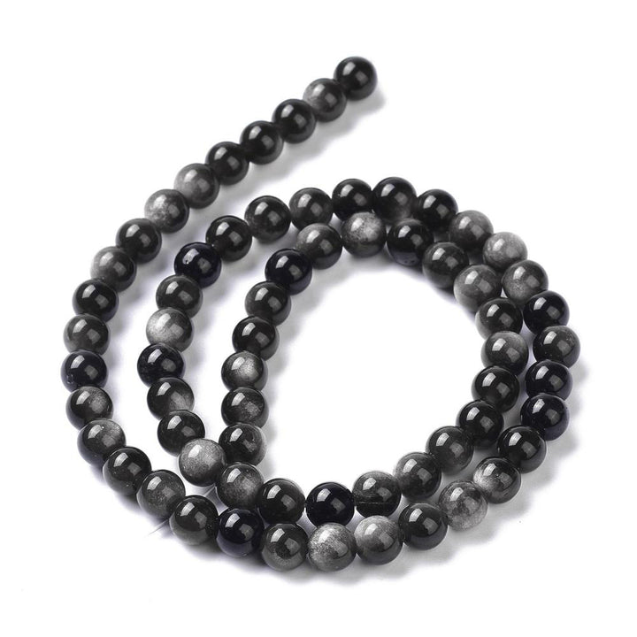 Silver Obsidian Beads, Black Color with Silver Markings. Semi-precious Gemstone Beads for DIY Jewelry Making.   Size: 6mm Diameter, Hole: 1mm approx. 62pcs/strand, 15 Inches Long.  Material: Genuine Natural Silver Obsidian Stone Beads, Black Color with Silver Markings.  Shinny, Polished Finish. 