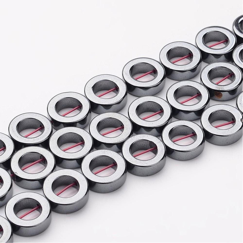 Donut Shaped Non-Magnetic Hematite Beads, Metallic Gunmetal Color. Semi-Precious Stone Beads for Jewelry Making. Affordable High Quality Beads for Mala Bracelets.  Size: 12mm Diameter, 4mm Thick, 6.7-7.2mm Inner Diameter, Hole: 1mm, approx. 33pcs/strand, 15 Inches Long.  Material: Grade AAA, Premium Quality Non-Magnetic Hematite Bead Strands. Metallic Gunmetal/Silver Colored Stone Beads. Polished, Shinny Metallic Lustrous Finish.